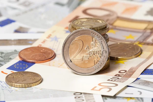 Some banknotes on five and fifty euros and coins — Stock Photo, Image