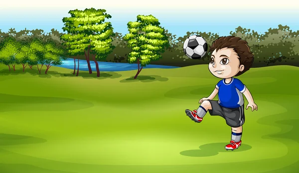 Um menino jogando futebol ao ar livre — Vetor de Stock