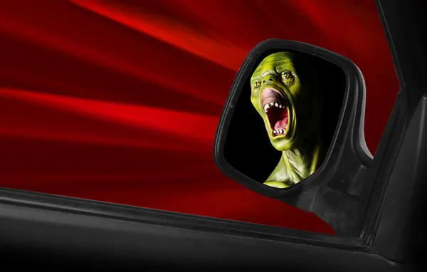 Screaming zombie in a speedy car. — Stock Photo, Image