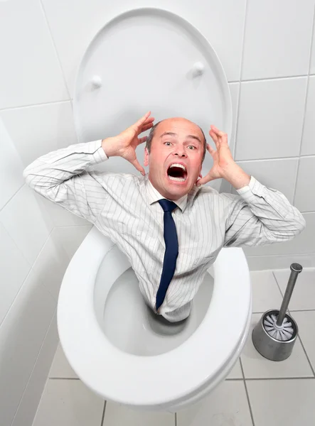 Frightened businessman screaming from toilet bowl — Stock Photo, Image