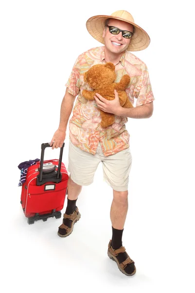 Funny european traveler with his suitcase and toys going to holidays — Stock Photo, Image