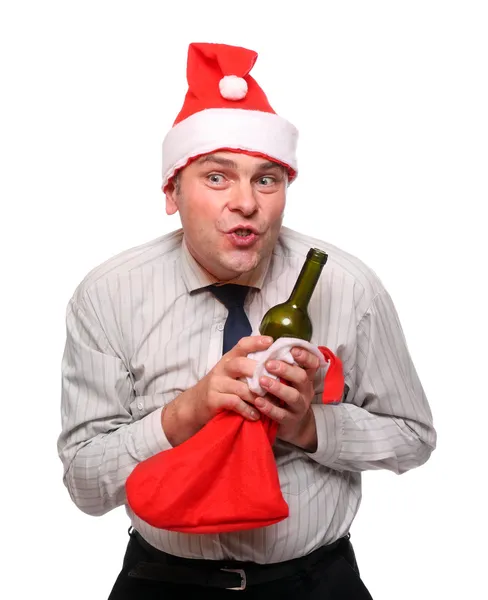Drinking businessman with Santa's cap and stocking. New Year celebration concept. — Stock Photo, Image