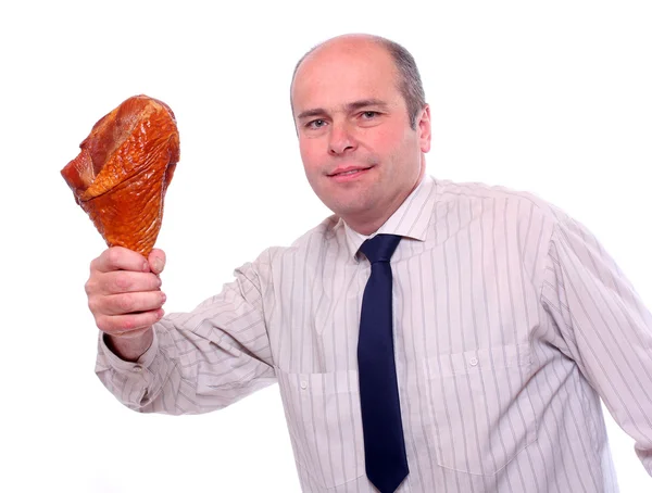 Hungriger Geschäftsmann isst Schinken. — Stockfoto