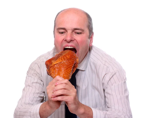 Hladový podnikatel jíst šunku. — Stock fotografie