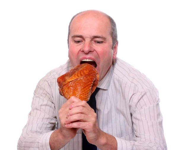 Hombre de negocios hambriento comiendo jamón . — Foto de Stock