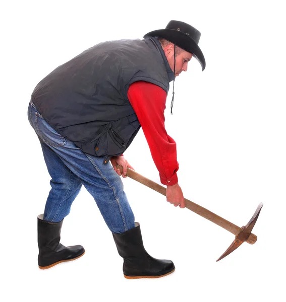 Cowboy mit Spitzhacke auf weißem Hintergrund. Metapher im Aufbau. — Stockfoto