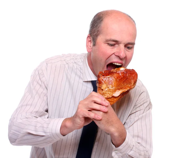 Hungry businessman eating ham. — Stock Photo, Image