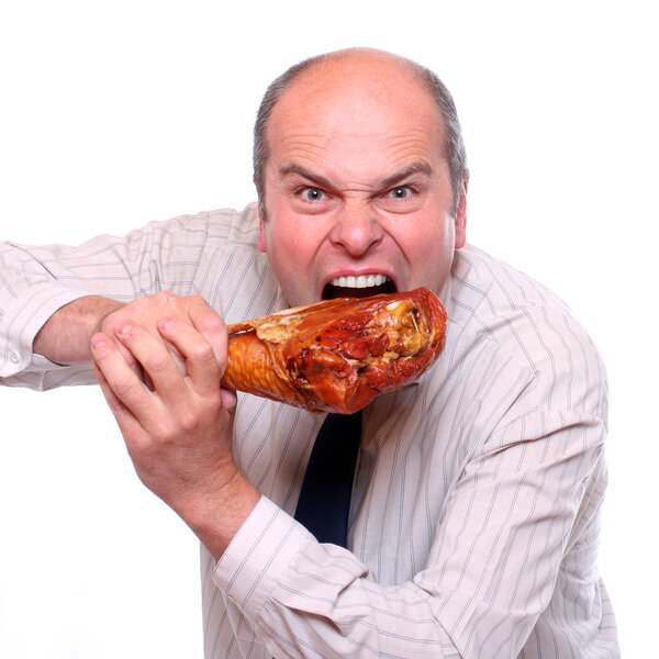 Hungry businessman eating ham.