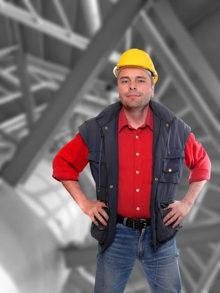 Professional builder against steel work. — Stock Photo, Image