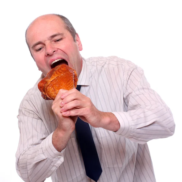 Hungry businessman eating ham. — Stock Photo, Image