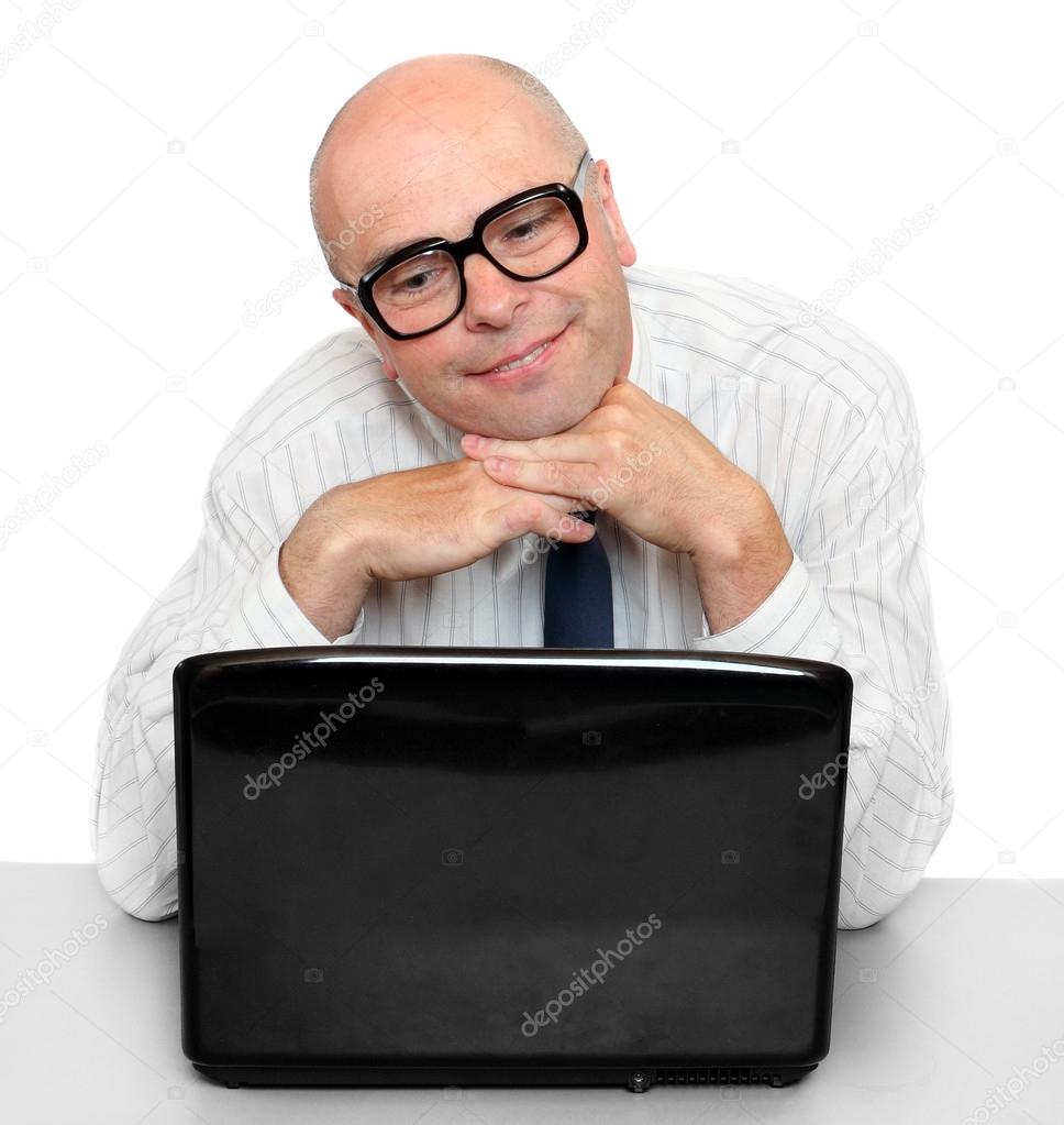Satisfied resting businessman with laptop on a desk in the office