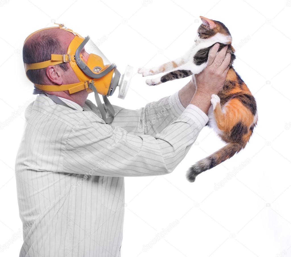Man in respirator holding his cat.
