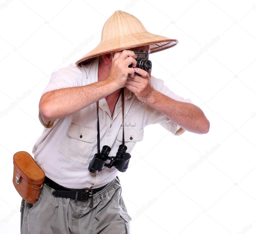 Photographer with camera dressed on suit for tropical destination