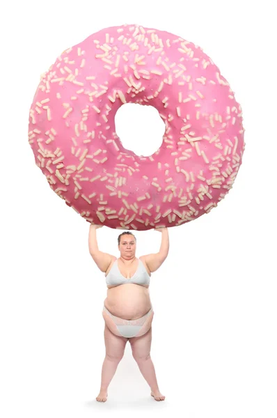 Överviktig kvinna eller stora rosa donut med kaninöron. — Stockfoto