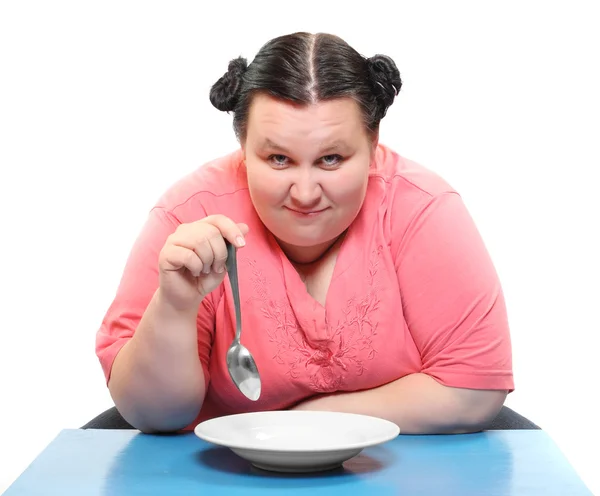 Hungrige fettleibige Frau mit leerem Teller. Lustiges Bild zum Thema Ernährung. — Stockfoto