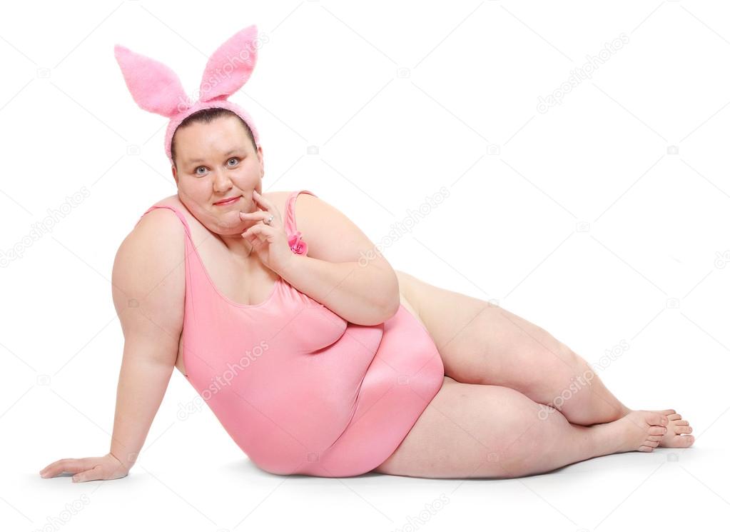 Overweight woman dressed in swimsuit on a white background.