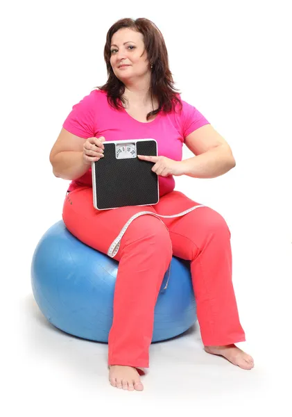 Overweight woman with weighing machine. — Stock Photo, Image