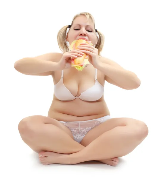 Overweight woman eating big sandwich with ham. — Stock Photo, Image