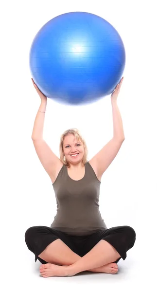 Overweight young woman with blue fitness ball — Stock Photo, Image