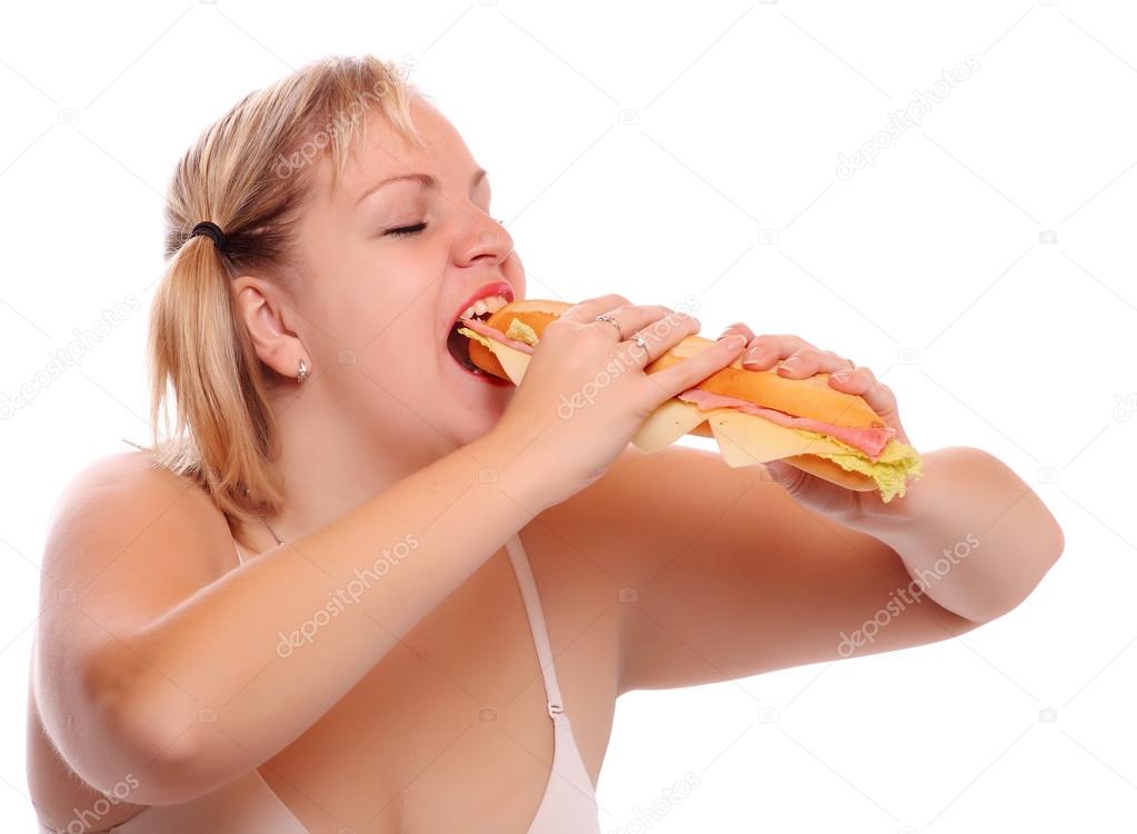 Funny picture of a hungry fatty eating big sandwich with ham.