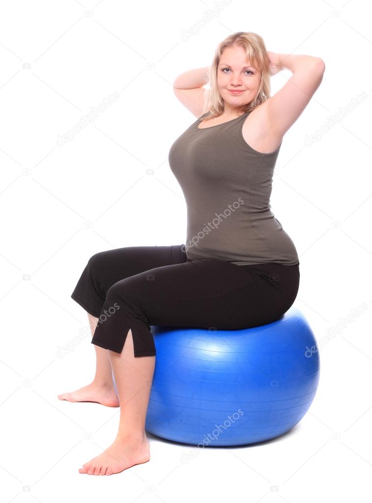 Overweight young woman with blue fitness ball