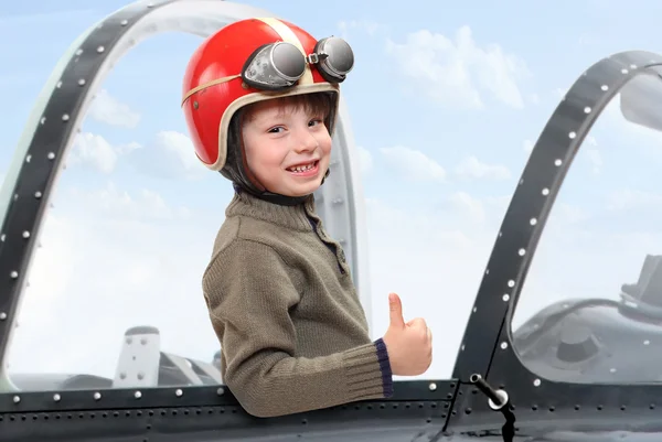 Little pilot in cockpit of a vintage plane. — Stock Photo, Image