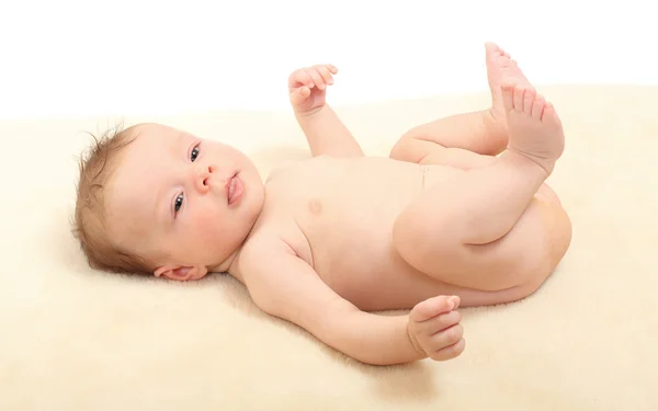 Happy baby lying on the bed. — Stock Photo, Image