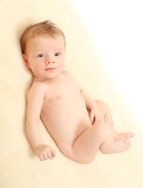 Happy baby lying on the bed. Royalty Free Stock Photos