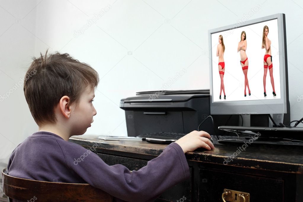 Little boy looking at computer with adult content