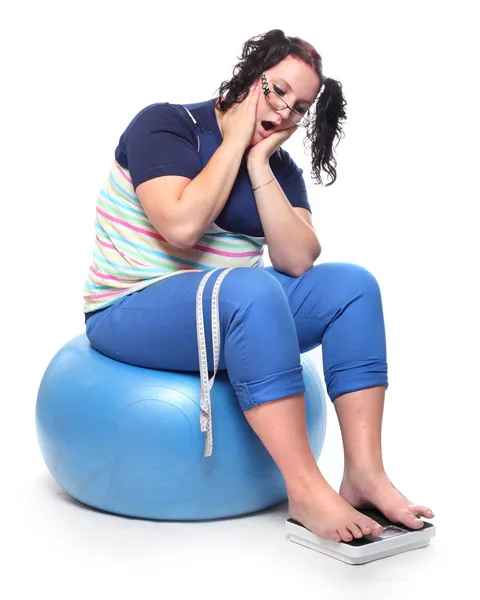 Frustrated woman with a weighing machine. — Stock Photo, Image