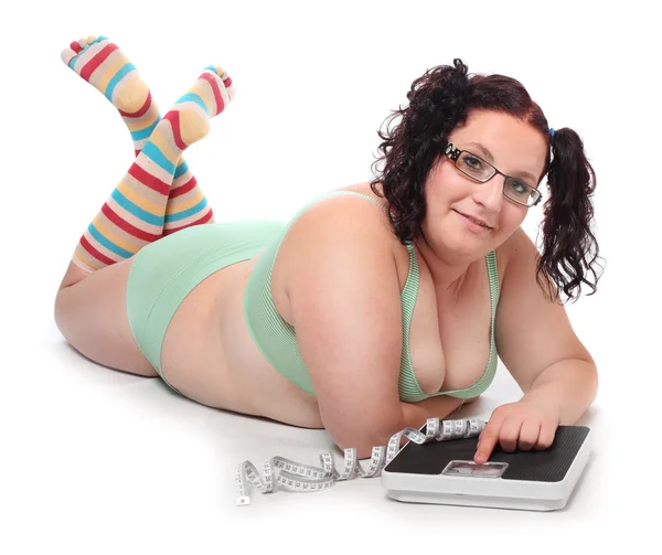 Overweight woman with a weighing machine. — Stock Photo, Image