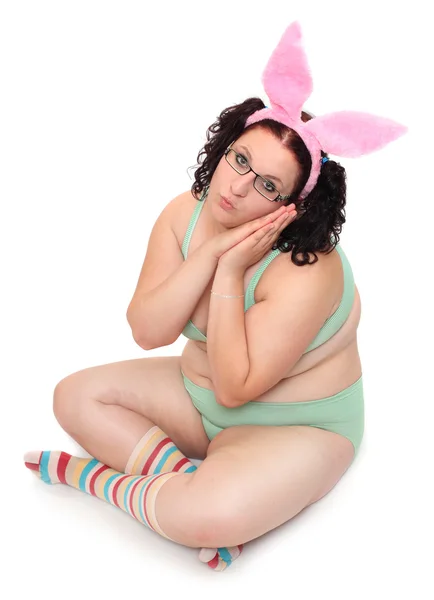 Overweight woman dressed in funny lingerie on a white background. — Stock Photo, Image