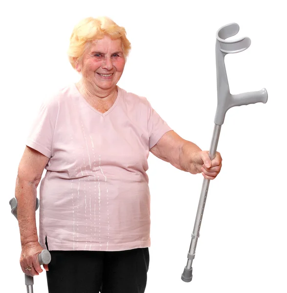 Happy elderly woman with her crutches. — Stock Photo, Image