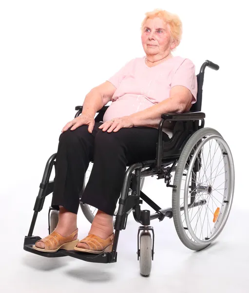 Mulher idosa paraplégica sentada em cadeira de rodas — Fotografia de Stock