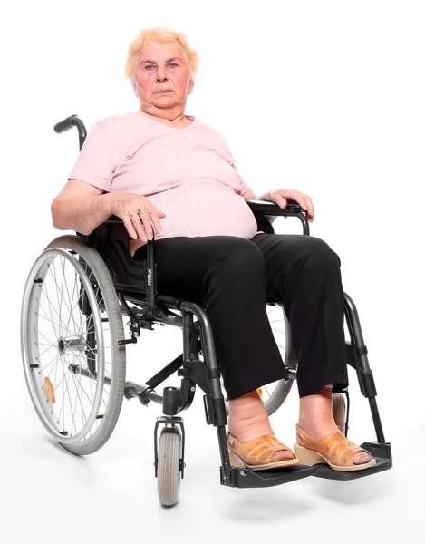 Elderly paraplegic woman sitting in a wheelchair — Stock Photo, Image