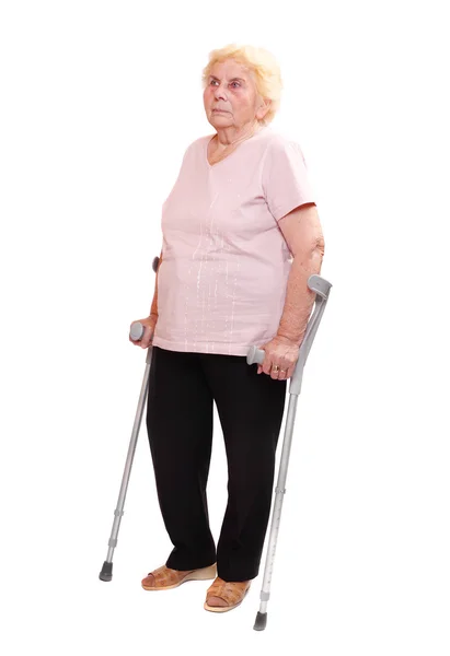 Elderly woman with her crutches. — Stock Photo, Image