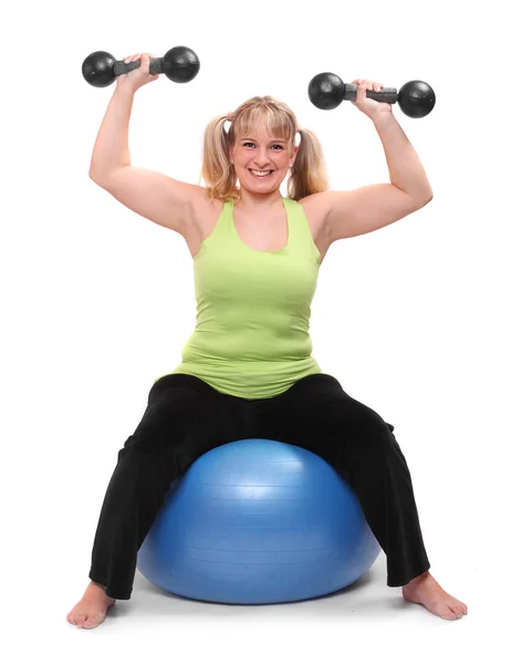 Woman exercise on a fitness ball with dumbells Stock Image