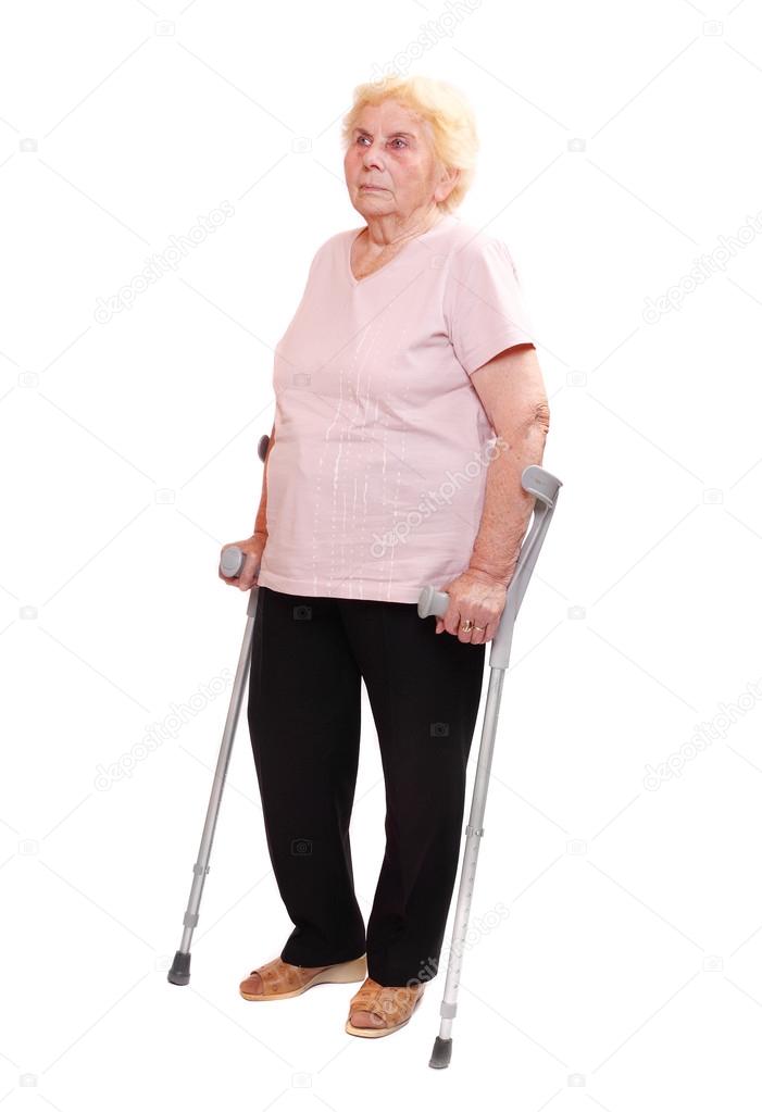 Elderly woman with her crutches.