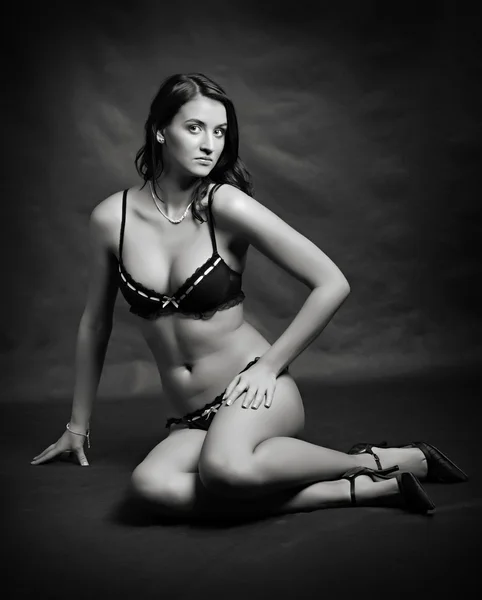 Studio shot young beautiful women dressed in black and white lingerie. — Stock Photo, Image