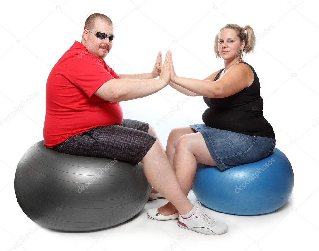 Overweight woman and man exercising sitting on blue fitness ball