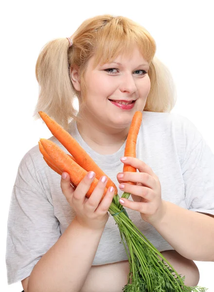 Overweight woman with fresh carrot. Weight loss concept. — Stock Photo, Image