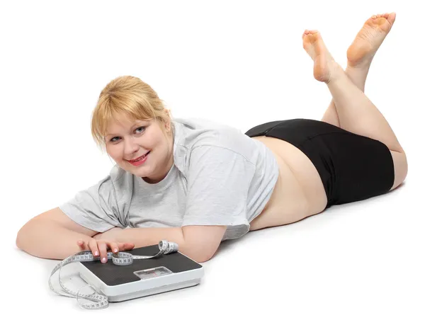 Mujer con sobrepeso sobre un fondo blanco . —  Fotos de Stock