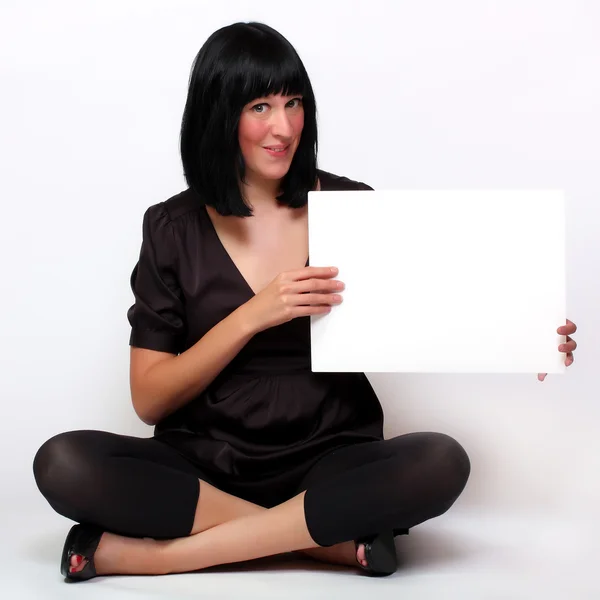 Beautiful woman holding empty white board — Stockfoto