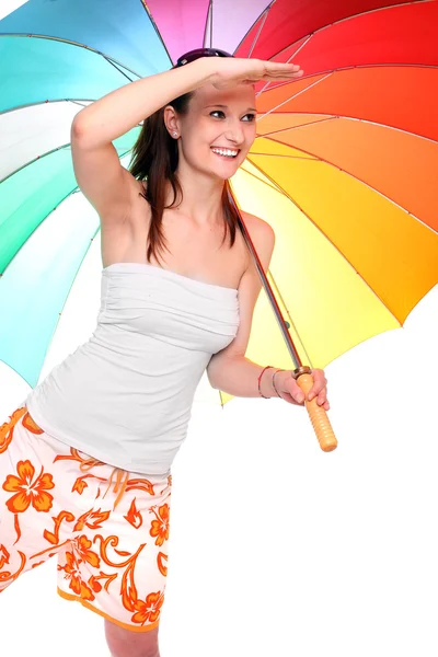 Ung kvinna går på semester med sin regnbåge paraply. — Stockfoto