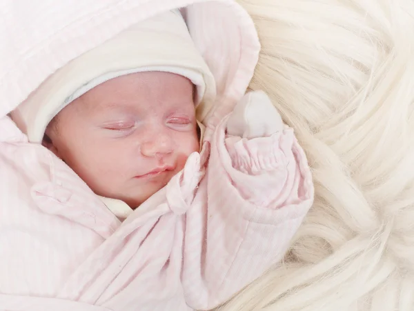 Cute baby on the fur. — Stock Photo, Image