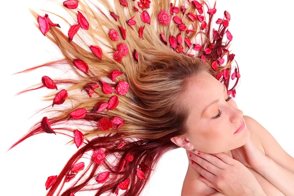 Beautiful young woman with flowers on her long hair. — Stock Photo, Image