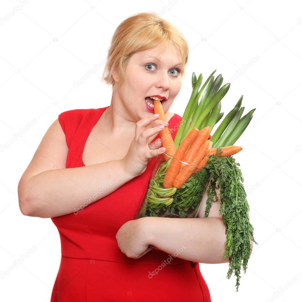 Overweight woman with fresh carrot. Weight loss concept.