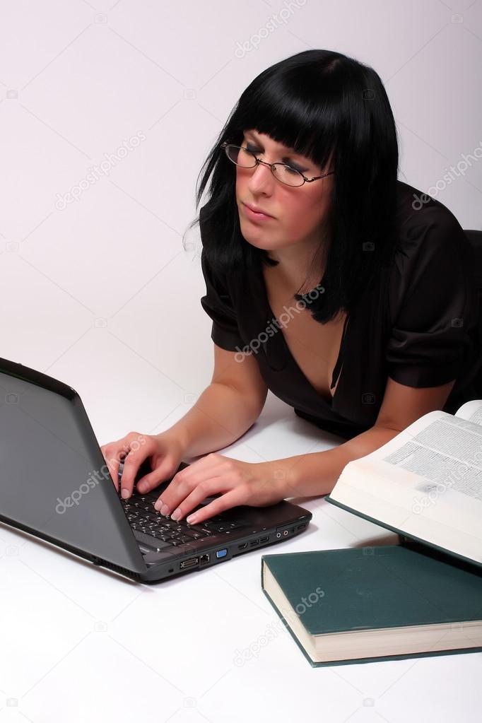 Portrait of a attractive business girl working on notebook.