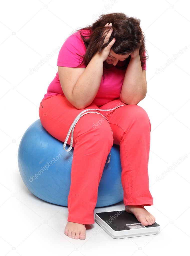 Overweight woman with weighing machine.