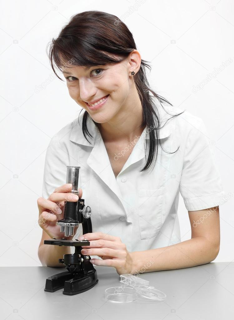 Female scientist with microscope.